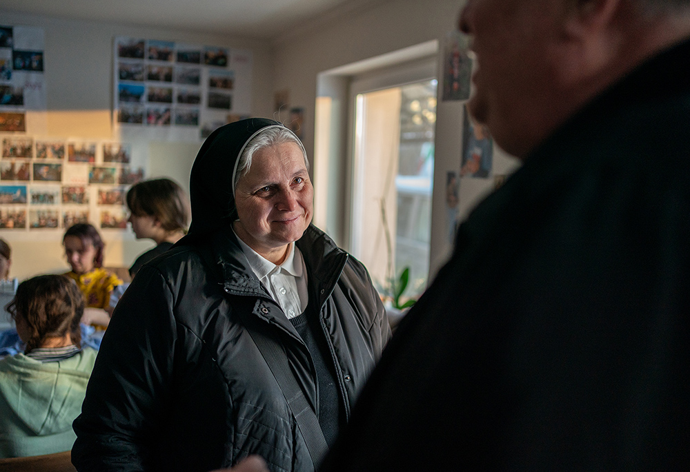 Dominican Sr. Edita Vozarova is pictured in a visit to the town of Serednje, near Mukachevo, Ukraine. Fr. Peter Zharkovskyi, right, a local priest with ties to Dominican sisters and to Caritas, is overseeing a project to expand housing for a group of displaced orphans and adults from the Russian-occupied city of Mariupol. (GSR photo/Gregg Brekke)