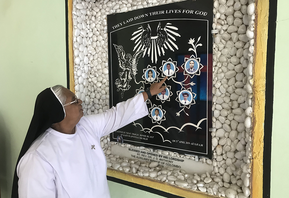 Dominican Sr. Sirima Opanayake, the principal of Ave Maria Branch School in Negombo, Sri Lanka, shows the pictures of the seven students killed in the Easter bombing at St. Sebastian's Church. (Thomas Scaria)