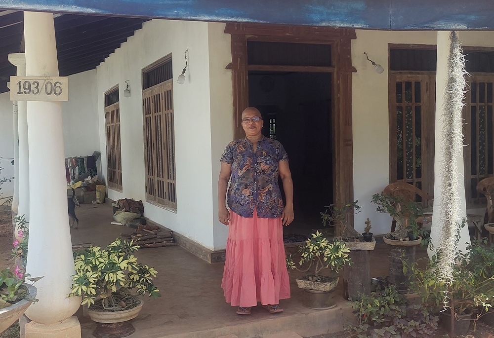 Niranjalee Yasawaradana, a widow who lost her husband and two daughters in the Easter bombing in 2019, stands in front of her house at Negombo, Sri Lanka. (Thomas Scaria)