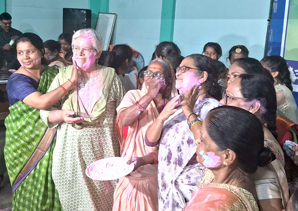 At our 2023 celebration of International Women's Day, coinciding with Holi, India's festival of colors, women cover each other in color, to symbolize coloring their lives. (Courtesy of Dorothy Fernandes)