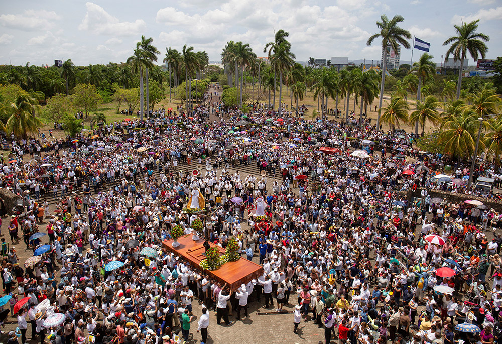 People gather for a Good Friday procession outside the Metropolitan Cathedral as the government banned Holy Week street processions this year due to unspecified security concerns, April 7 in Managua, Nicaragua. Parishes in Nicaragua conducted traditional Viacrucis processions on church grounds or inside churches. (OSV News/Reuters)