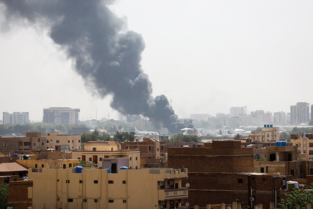 Black smoke rises from a burning building in Khartoum, Sudan