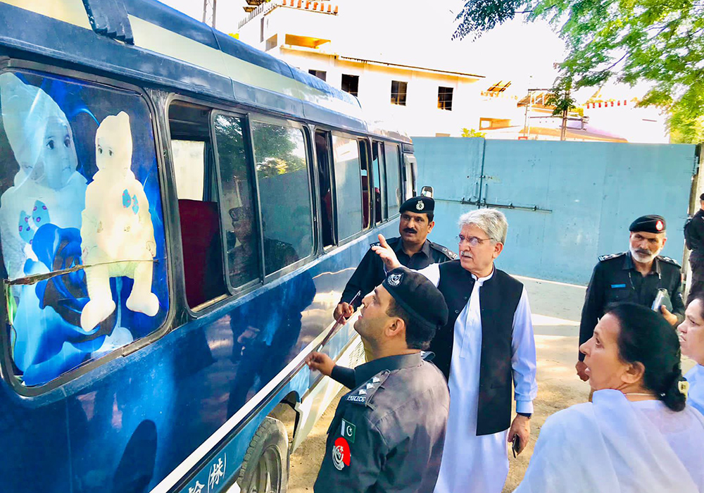 Presentation Sisters and the police investigation team are pictured with the attacked school van of Sangota Public School in Swat Valley, Pakistan. (Courtesy of Sr. Teresa Younas)
