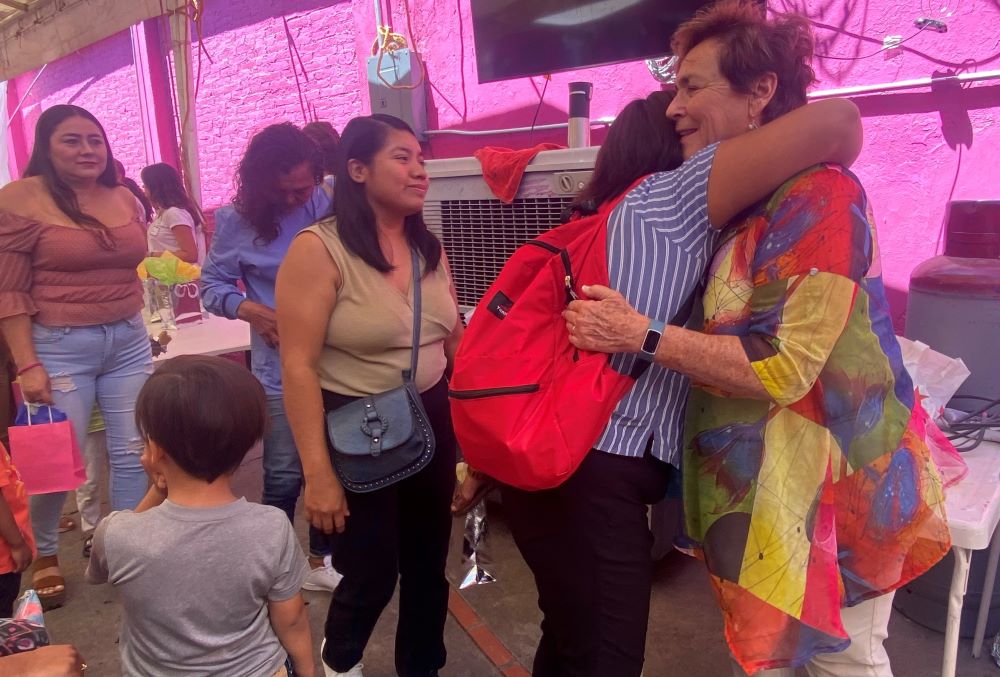 St. Joseph of Carondolet Sr. Suzanne Jabro receives a hug from a woman at the Cobino shelter in Mexicali, Mexico May 10, when women religious arrived to mark Mother's Day. The visit came a day before the U.S. lifted a public health measure that kept migrants from applying for asylum during the coronavirus emergency. (GSR photo/Rhina Guidos)