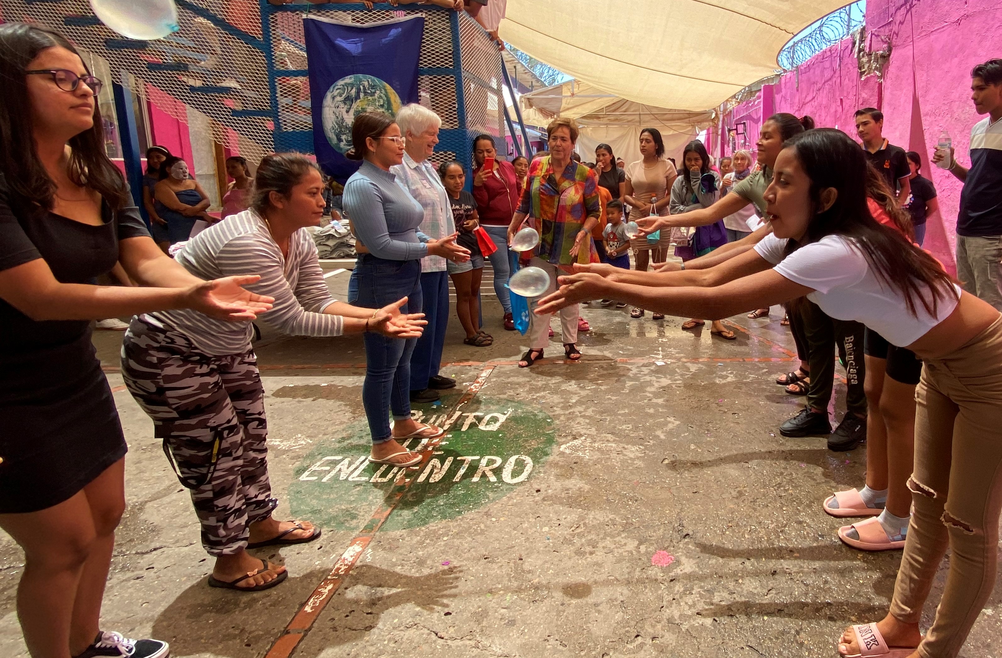 Migrant women play a game with water balloons at the Cobino migrant shelter in Mexicali, Mexico May 10. The games were part of a visit by women religious who arrived with gifts and food for the migrants to mark Mother's Day. (GSR photo/Rhina Guidos)