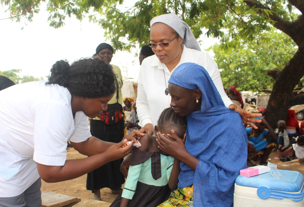 Patience Iremiah, 9, receives the first of three HPV vaccine doses in the New Kuchingoro IDP Camp in Abuja, Nigeria, on March 25. The vaccine protects against infections and cervical precancers. (GSR photo/Valentine Benjamin) 