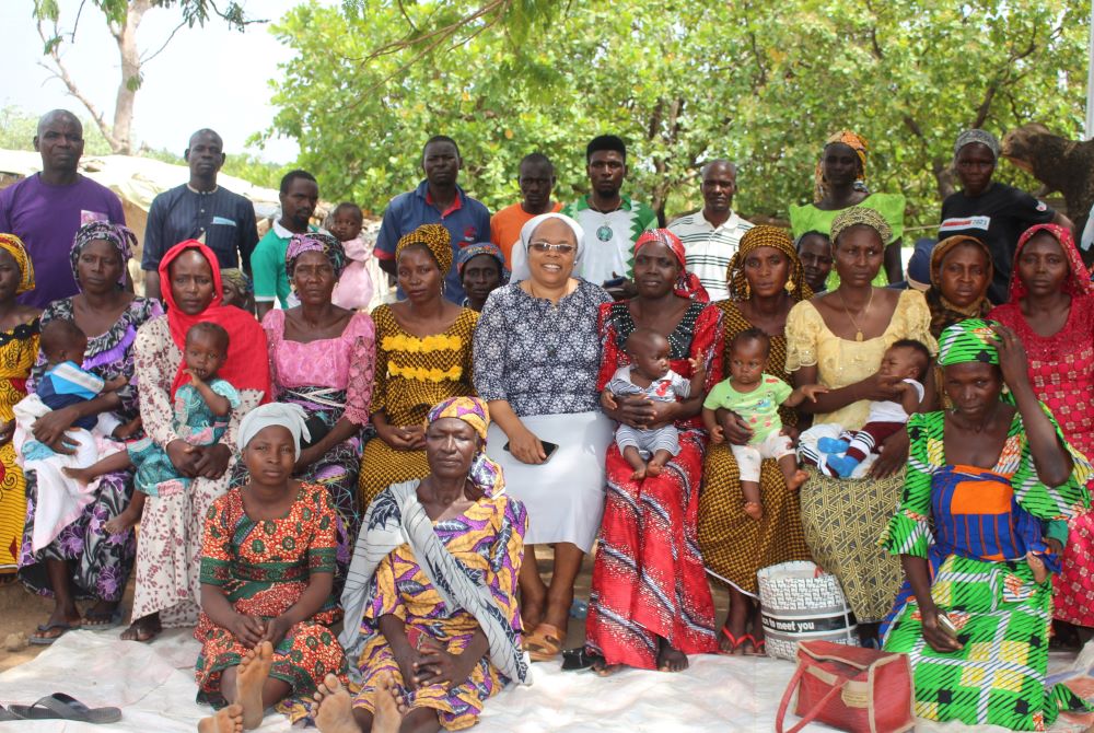 Sr. Dumka Michael (center), administrator and project officer for the program that the Medical Missionaries of Mary run at the New Kuchingoro IDP camp in Abuja, Nigeria, sits for a group photo March 25. (GSR photo/Valentine Benjamin)