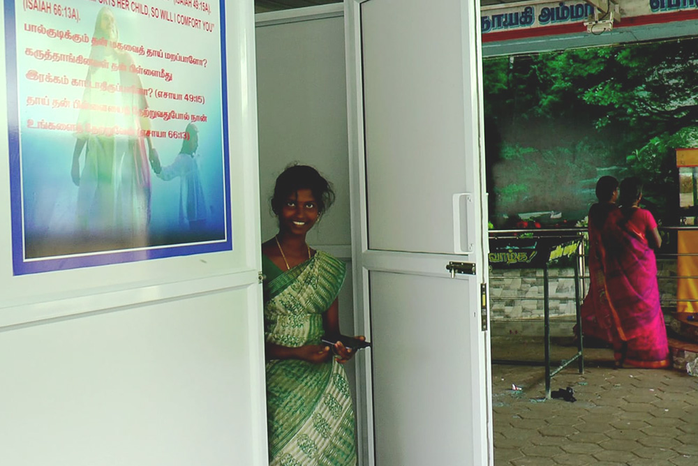 A young woman is seen at the door to the breastfeeding room at Our Lady of Periyanayagi Shrine in Konankuppam, Kallakurichi district, Tamil Nadu, India. (Donald Reegan)