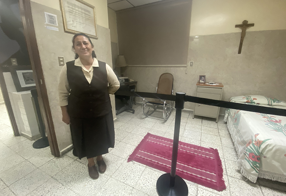 Sr. Ruby Lemus Salguero stands in front of a room where St. Oscar Romero lived and worked, as pilgrims visited the house March 24, on the grounds of the Divine Providence Hospital in San Salvador, El Salvador. Missionary Carmelites of St. Teresa care for the house where he lived on the grounds of the hospital for poor cancer patients that the religious community still operates. (GSR photo/Rhina Guidos)