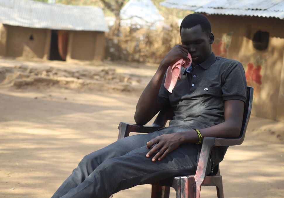 A youth from the Dinka tribe cries at the Kakuma Refugee Camp Feb. 17 as he recounts the horrors he experienced at the hands of Nuer rebels in South Sudan before seeking refuge at the camp. (GSR photo/Doreen Ajiambo)