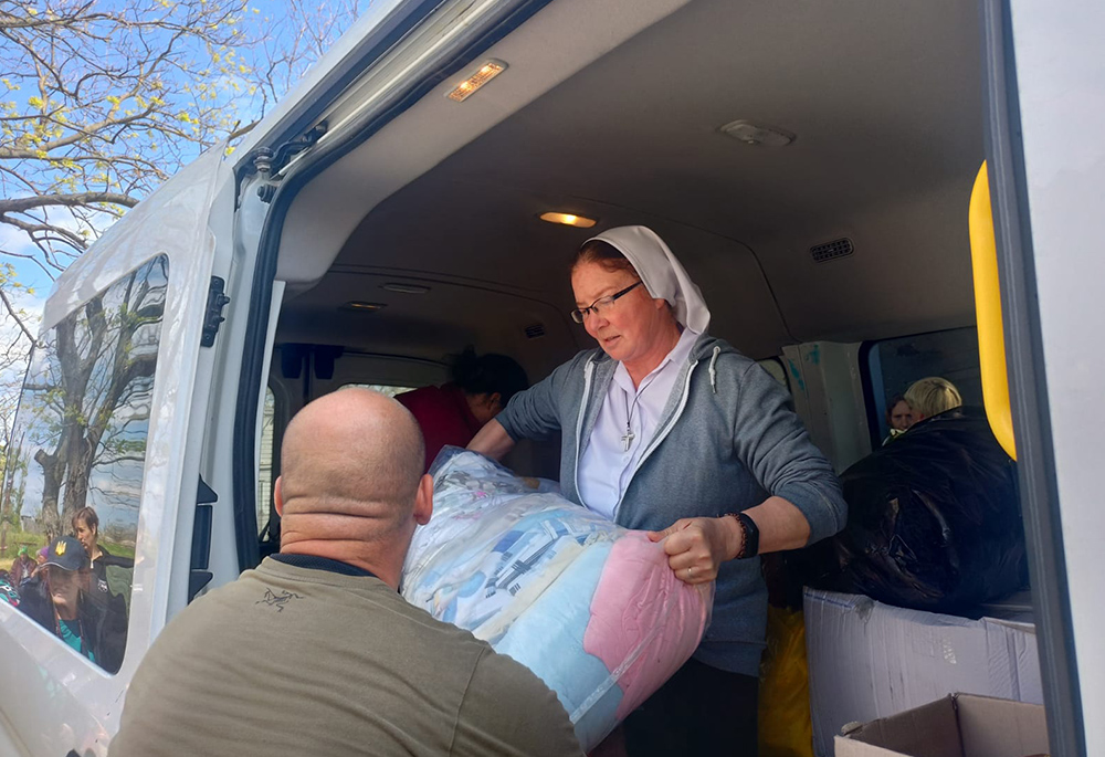 Sr. Lydia Timkova helps unload humanitarian supplies during a recent mission to war-torn eastern Ukraine, in villages near Mykolaiv. (Courtesy of Sr. Lydia Timkova)