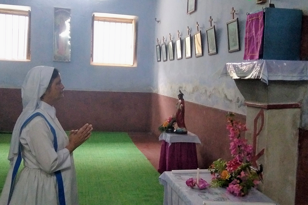 Sr. Mary Rina Magdeline Cruze prays in the chapel on the Kumudini Nursing Institute premises in Tangail, Bangladesh. (Sumon Corraya)