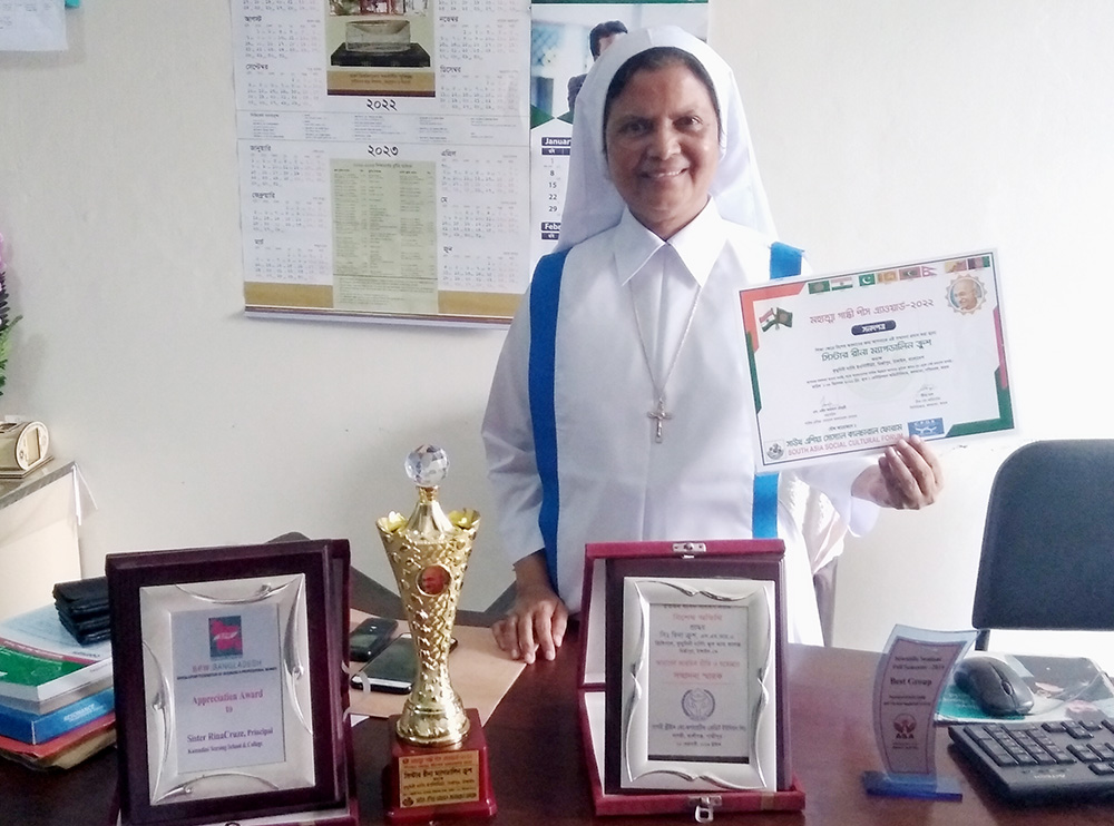 Sr. Mary Rina Magdeline Cruze with awards she has won, including the Mahatma Gandhi Peace Award 2022, in her office in Kumudini Nursing College in March in Tangail, Bangladesh (Sumon Corraya)