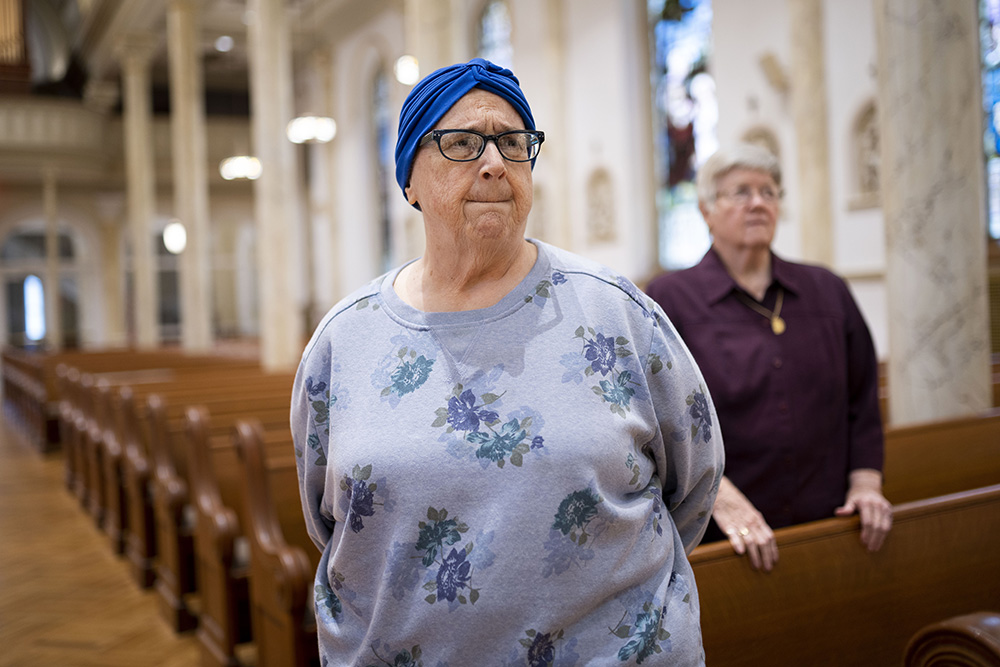 Sr. Claire Regan and Sr. Dorothy Metz stand in a chapel