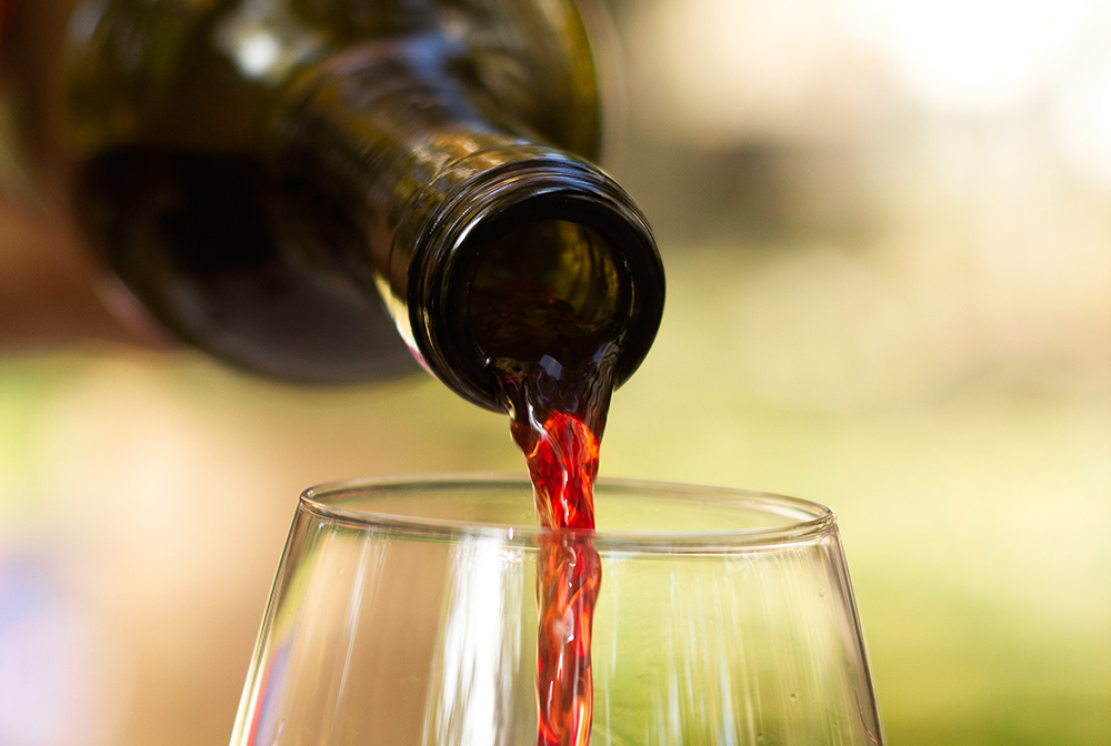 Pouring wine (Unsplash/Christine Isakzhanova)