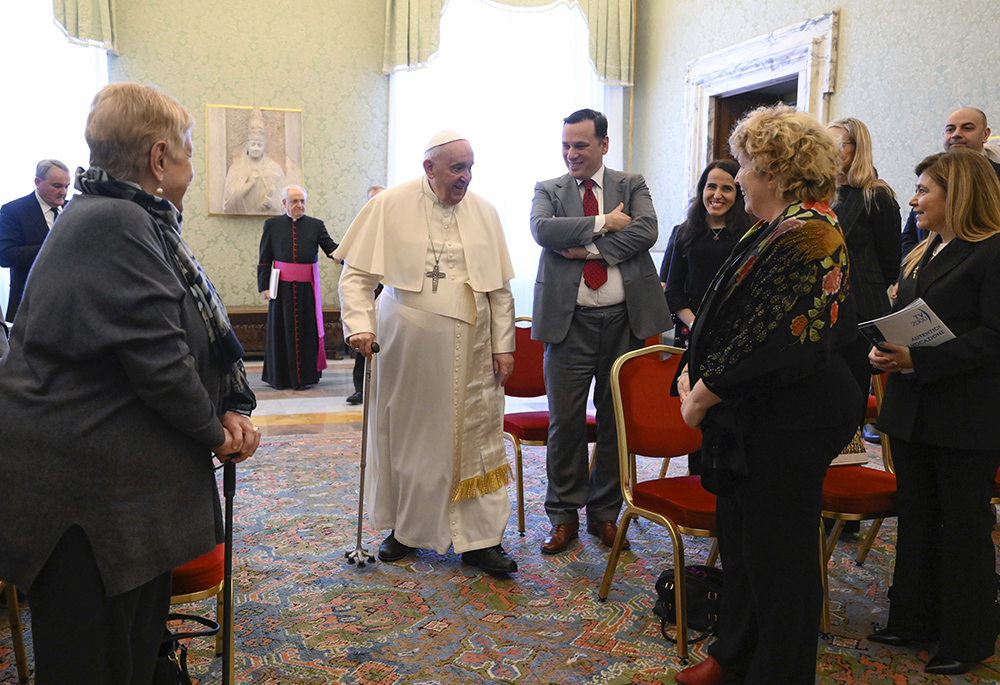 Pope Francis greets staff members of the Vatican newspaper's monthly insert dedicated to women during an audience March 4 at the Vatican. To the pope's left stands Andrea Monda, director of the Vatican newspaper, L'Osservatore Romano. The newspaper's supplement, "Women, church, world," was launched in May in 2012. (CNS/Vatican Media)