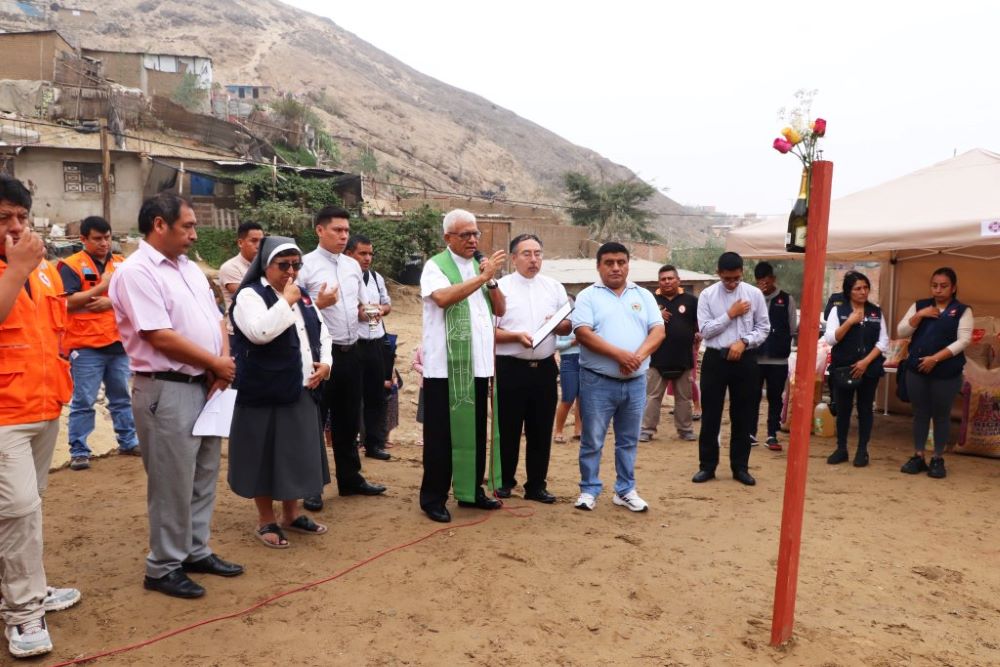 Archbishop Miguel Cabrejos Vidarte of Trujillo, Peru, visits a settlement in La Esperanza district, in Trujillo, on June 5, 2023, and donates two houses to residents who lost their homes during the floods that hit northern Peru in March. The rains and floods helped to propagate the dengue virus epidemic in the country, which resulted in at least 248 deaths and 146,000 cases. (OSV News Photo/courtesy Trujillo Archdiocese)