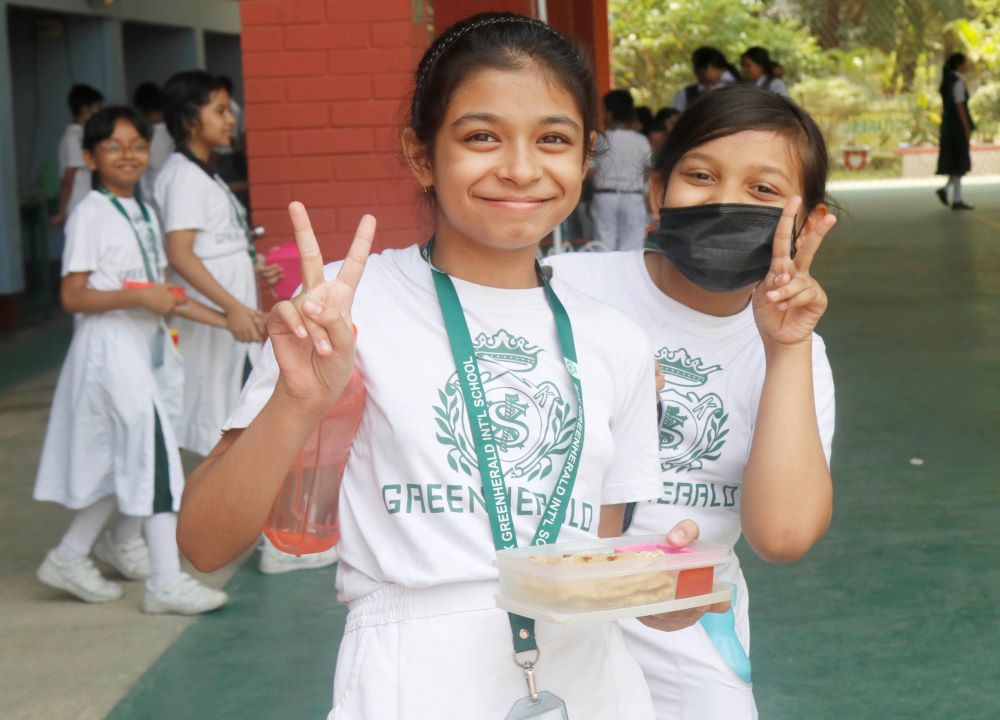 Two students pose for a photo on the grounds of the S.F.X. Greenherald International School in Dhaka, Bangladesh. The school is the first English-language school in Bangladesh after the country's independence in 1971. (Uttom S. Rozario)