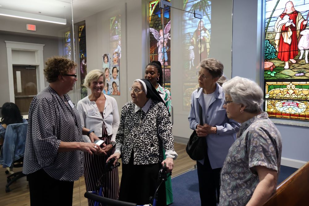 St. Joseph Children's Home CEO Grace Akers and Chief Advancement Officer Suzy Hillebrand speak with Srs. Loretta Guenther, Rita Dressman and Barbara Bir in the chapel while Caitlyn Green looks on. (Courtesy of Ursuline Sisters of Louisville/Kathy Williams)