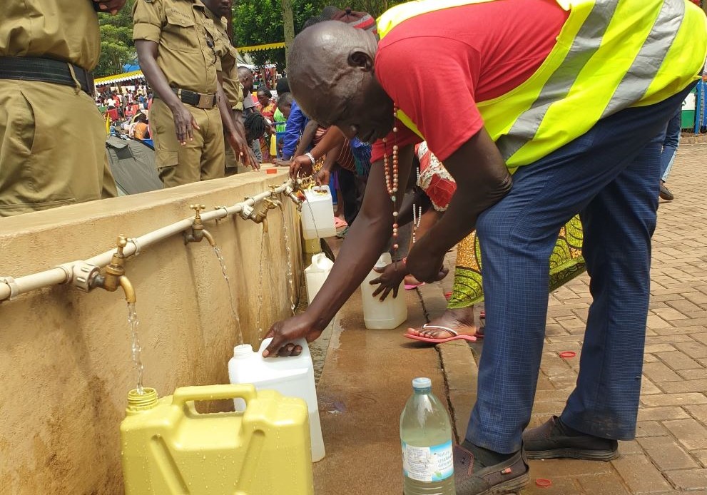 Picture 13: Pilgrims fill jerrycans with holy waters at the Uganda Martyrs Shrine at Namugongo. Many pilgrims who flock to Namugongo to celebrate Martyrs Day believe that the water from the nearby lake possesses holy powers. (GSR photo/Gerald Matembu)