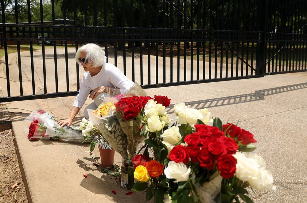 Janice Vonada of Keller, Texas, places roses at the gate to the Monastery of the Most Holy Trinity of the Discalced Carmelite Nuns of Arlington in Arlington, Texas, May 31. 