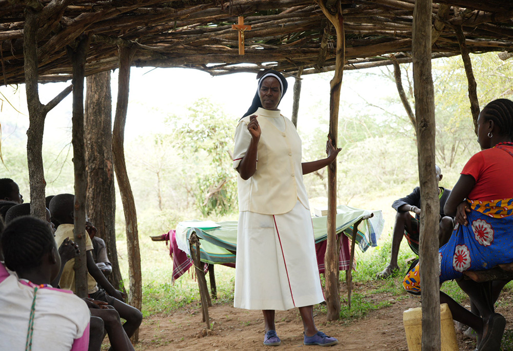 Incarnate Word Sr. Jannifer Hiuhu leads the Sunday service at a makeshift church in Sugut village, located about 40 kilometers (about 25 miles) from the sisters' outpost in Rotu village. In the absence of the three Holy Ghost Fathers who scatter throughout East Pokot to serve Mass, the sisters take on the responsibility of leading the Sunday service. Afterward, they distribute food aid to women and the elderly who are the most vulnerable to starvation from the drought. (GSR photo/Wycliff Peter Oundo)