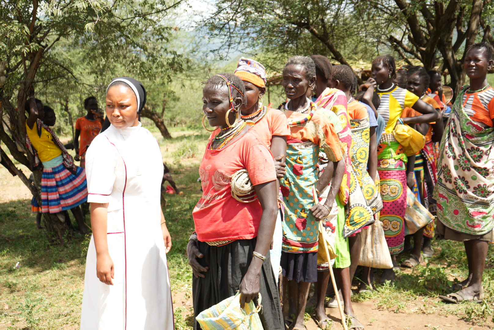 Sr. Annestacia Wanza oversees a line of senior women waiting eagerly with sacks for their supplies of maize rations. The "Food for Women and Elderly" initiative by the Incarnate Word Sisters caters to the most susceptible group to starvation, as many of them cannot keep up with the nomadic lifestyle of the Pokot people given their age. (GSR photo/Wycliff Peter Oundo) 