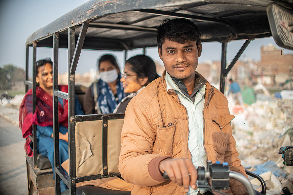 Raja Ram, 26, worked as a porter in a factory before COVID-19 hit Delhi. He lost his job when the company closed during a three-month lockdown. He obtained a used electric rickshaw, but it came without a battery. With financial assistance from Chetanalya, a nonprofit, he bought a battery and started earning again. (Photo courtesy of Mubeen Siddiqui/ICMC)