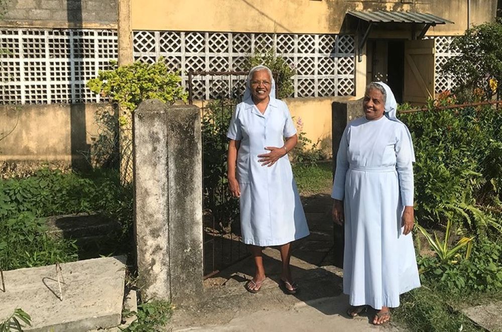Salvatorian Srs. Rani Fernando, left, and Selvarani Fernando (no relation) stand outside their apartment in Don Boscopura, a tsunami rehabilitation enclave in Negombo, Sri Lanka. (Thomas Scaria)