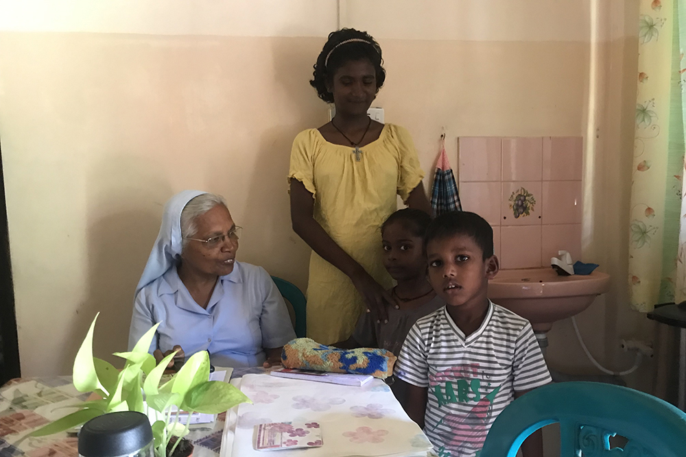 Salvatorian Sr. Rani Fernando with children of the Don Boscopura neighborhood who came to greet her before starting a tuition class in Negombo, Sri Lanka (Thomas Scaria)