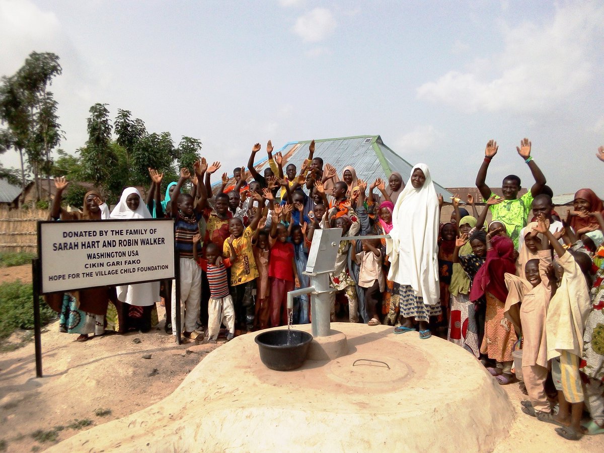 Women and children celebrate the commissioning of a new water source in their community provided by the Hope for the Village Child Foundation. (Provided photo)