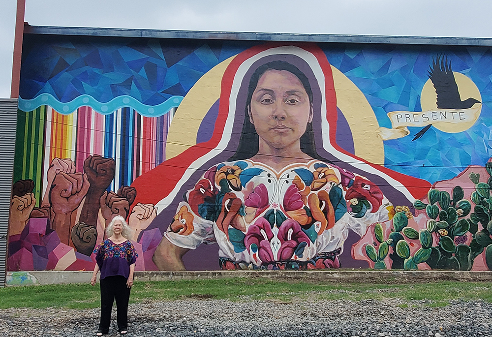 Sr. Martha Ann Kirk stands by “Mujerista #3" Mural No. 57, community art sponsored by the San Antonio Cultural Arts Center. The lead artists are Ana Hernandez and Rhys Munro. Kirk's name is painted on the right as a community member who encouraged this creation. (Courtesy of Martha Ann Kirk)
