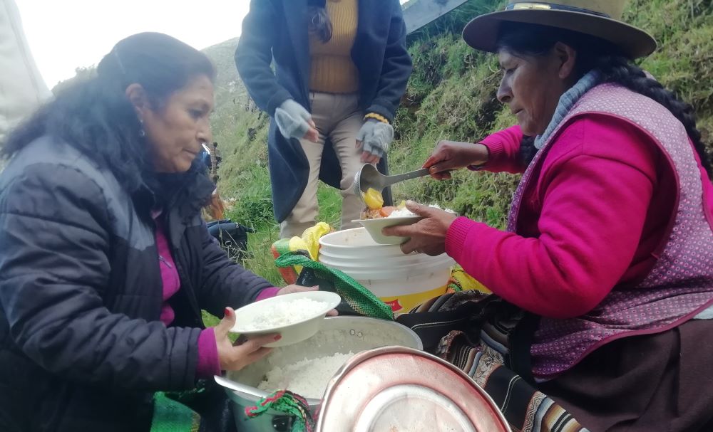 Farmers and locals from the village of Cotacombas share lunch in the field before their pilgrimage to the ecological sanctuary of Ccoñamuro, dedicated to the Virgin, Queen of Peace. (Courtesy of Diana Villarreal)