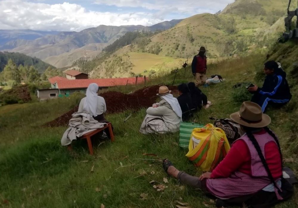 Farmers and residents of the village of Cotacombas, Peru, share a lunch of chicken stew in the countryside. Augustinian Sisters of the Conversion Monastery spent 10 days with the community in the Andes. (Courtesy of Diana Villarreal) 
