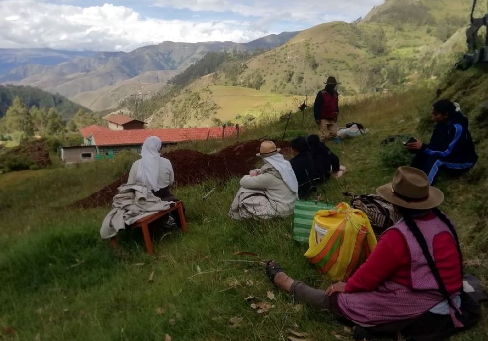 Farmers and residents of the village of Cotacombas, Peru, share a lunch of chicken stew in the countryside. Augustinian Sisters of the Conversion Monastery spent 10 days with the community in the Andes. (Courtesy of Diana Villarreal)