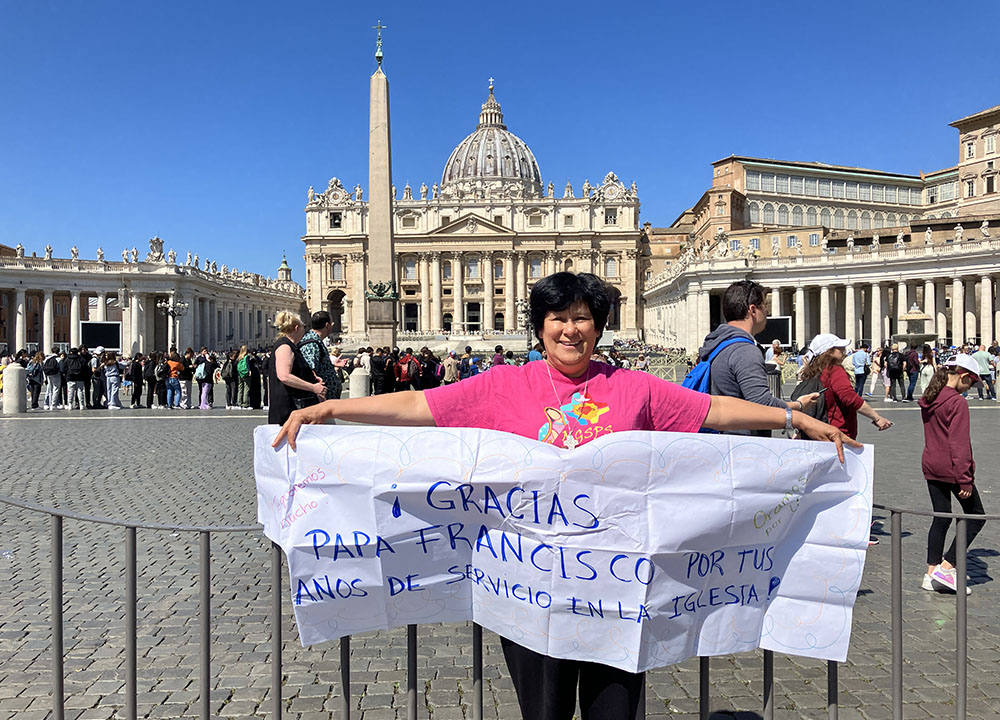 Sr. María Elena Méndez Ochoa stands in front of the Vatican with a sign she made to congratulate Pope Francis on his 10th anniversary as pope. (Gabriela Ramirez).