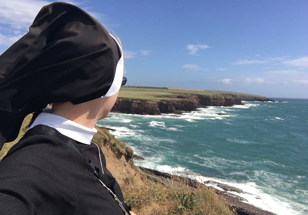The author is pictured on a hike along the Dunmore East Cliff Walk in County Waterford, Ireland, during her annual retreat in August 2022. (Courtesy of Kathryn Press)