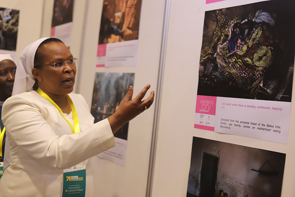 During a July 18 side event of the Women Deliver 2023 Conference in Kigali, Rwanda, Sr. Jane Wakahiu explains an image in which a woman is breastfeeding a newborn baby lying on the floor. Wakahiu, of the Institute of the Little Sisters of St. Francis, also highlighted some of the challenges women in poverty experience. (GSR photo/Doreen Ajiambo)