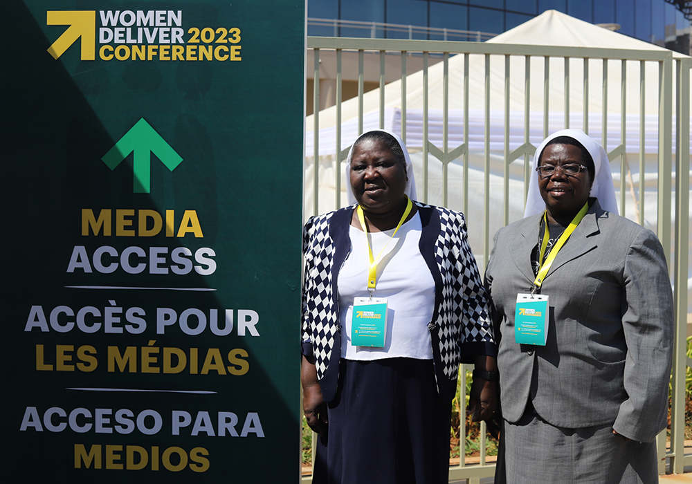 Sr. Rosemary Nyirumbe, a member of Sisters of the Sacred Heart of Jesus, and Sr. Josephine Anto, a member of the Society of the Holy Child Jesus, pose for a photo outside the arena where the Women Deliver 2023 Conference is taking place, July 17 in Kigali, Rwanda. (GSR photo/Doreen Ajiambo)