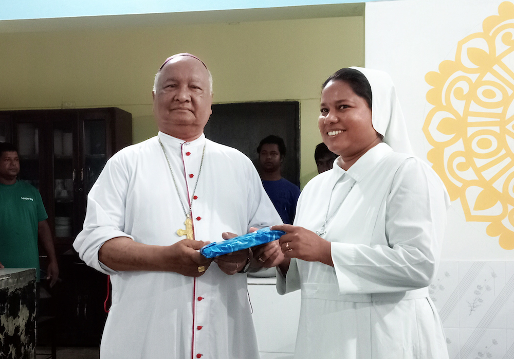 Our Lady of Sorrows Sr. Shibly Carmel Purification presents her book Silent Presence of God to Bishop Gervas Rozario of the Rajshahi Diocese in Bangladesh for its unveiling June 20. (Uttom S. Rozario)
