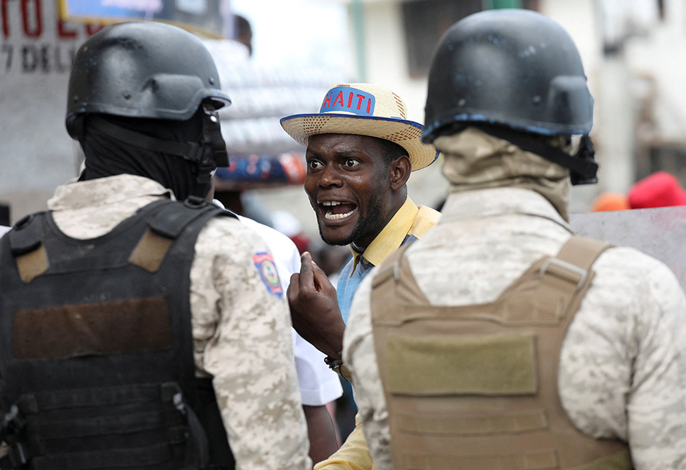 A demonstrator shouts at police during protests demanding that the government of Haitian Prime Minister Ariel Henry do more to address gang violence, including constant kidnappings, March 29, 2022, in Port-au-Prince. A coalition of religious orders working at the United Nations has written to U.N. officials, asking them to address the reign of terror of armed gangs they described as "diabolical, frightening and unacceptable." (CNS/Reuters/Ralph Tedy Erol)