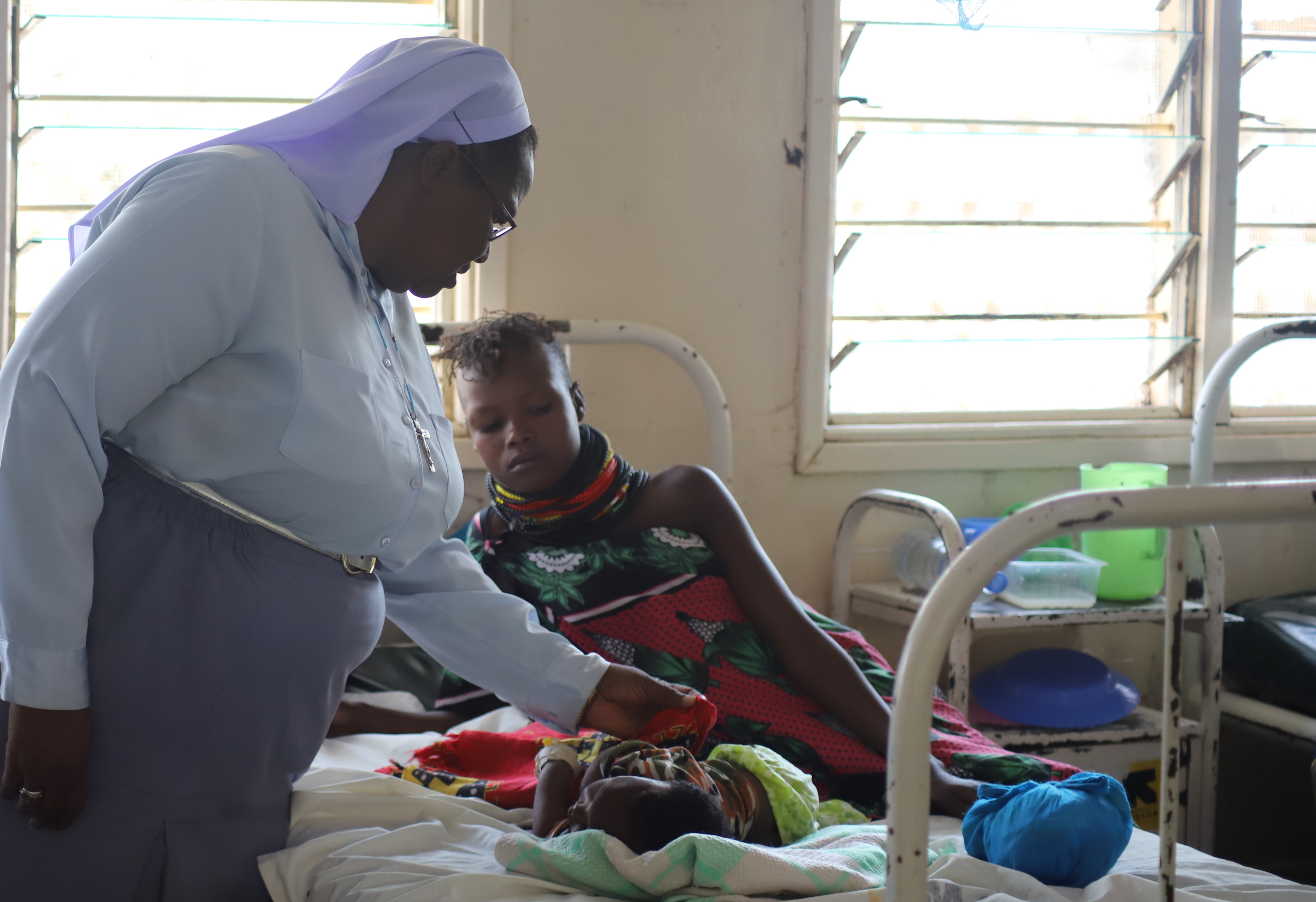Photo 2: Sr. Petronella Mueni examines a sick baby admitted at the Kakuma Mission Hospital in February. The hospital in northwest Kenya provides quality health care for refugees and residents. (GSR photo/Doreen Ajiambo)