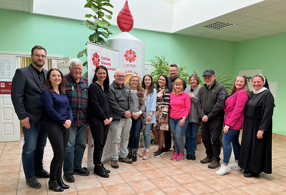 Caritas Poland staff and psychologists in Rzeszow are pictured with visitors from the U.S., including Jim McDermott, former U.S. representative, third from the left; NCR contributor Fr. Peter Daly, fifth from the left; and NCR board member David Bonior, former U.S. representative, third from the right. (Courtesy of David Bonior)