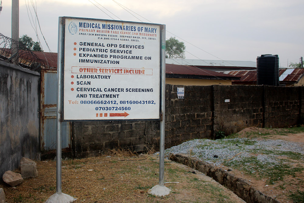 A signpost near the clinic's entrance informs the public about the Medical Missionaries of Mary's health care services in Lugbe, Abuja, Nigeria. (GSR photo/Valentine Benjamin)
