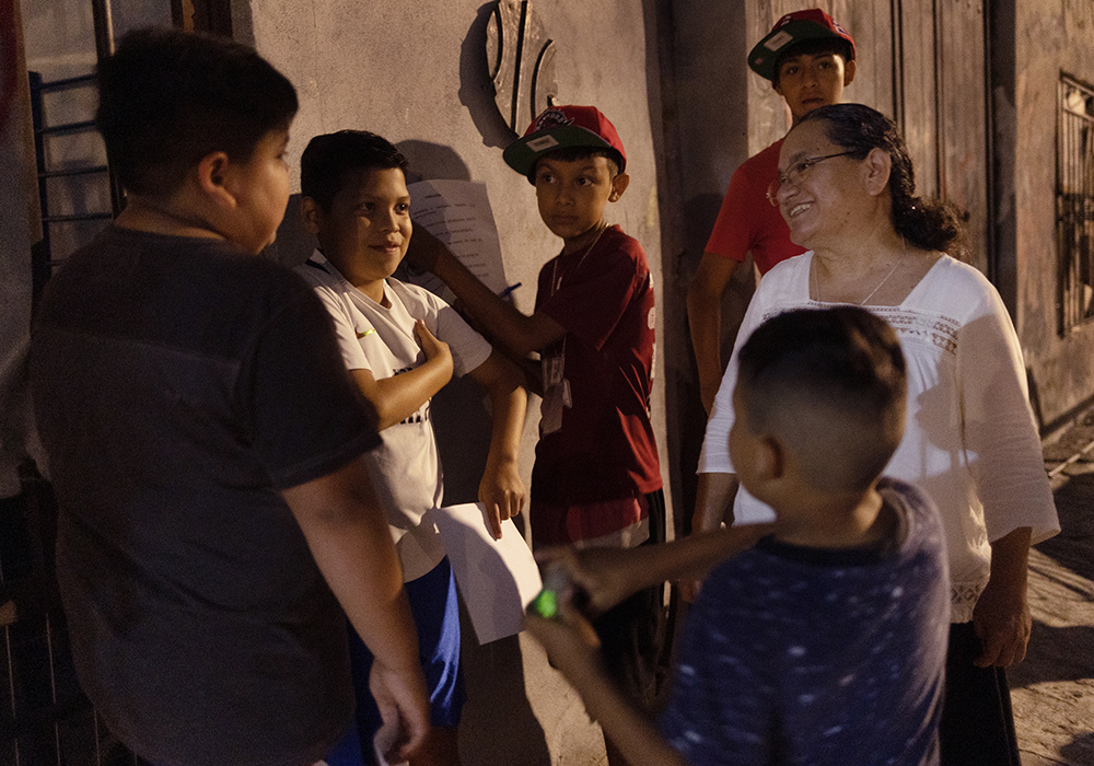 Sr. Sanjuana Morales Nájera visits with members of Los Monckis, a youth gang in Monterrey, Mexico, as part of her community's mission to evangelize and minister to young people. (Nuri Vallbona)