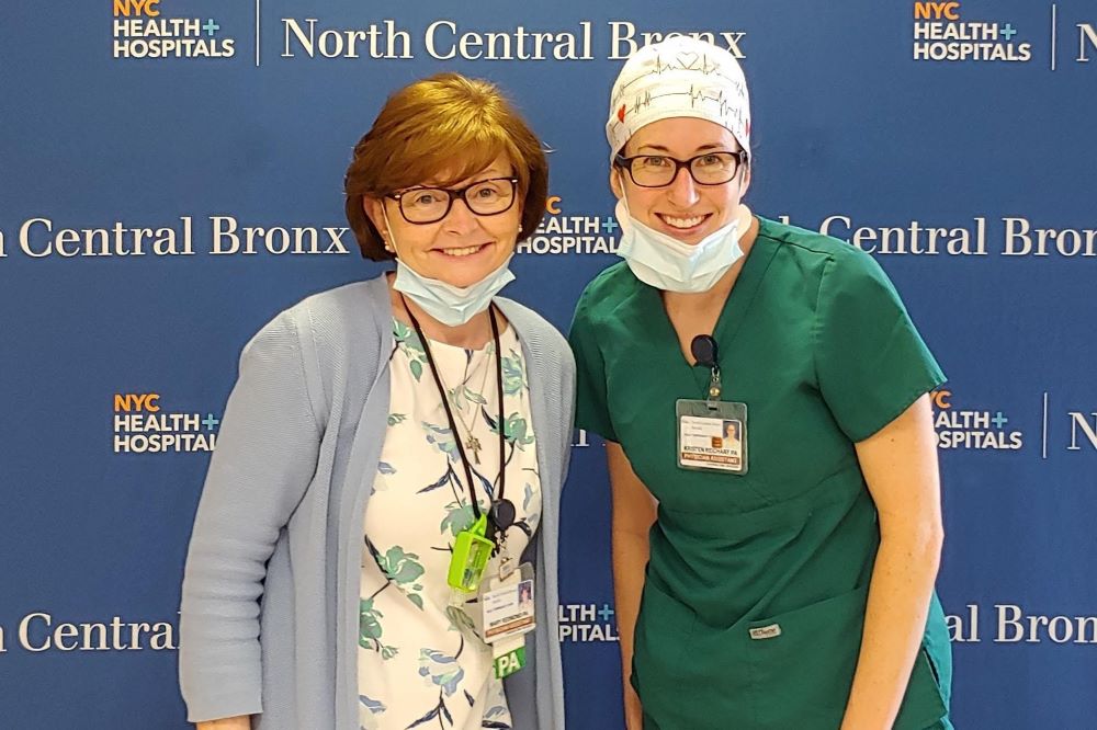 Sr. Mary Catherine Redmond, left, stands with physician assistant Kristen Reichart after an operations meeting for planning at the hospital where she worked during the early days of the COVID-19 pandemic. 