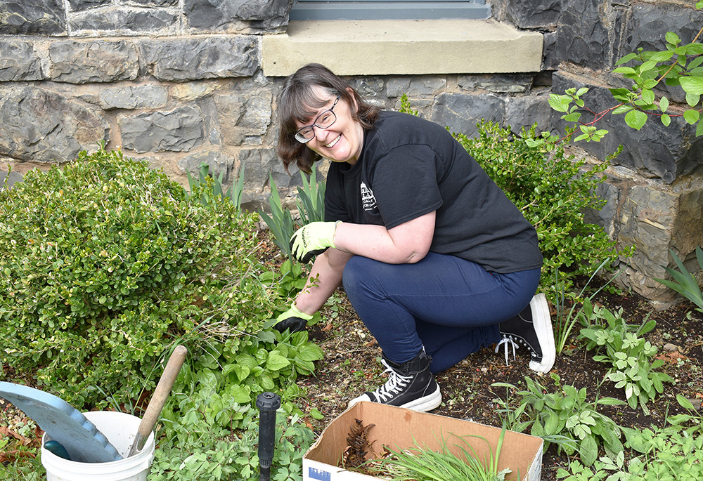 Sylvia Bognar of Alberta, Canada, works in a flower bed during a May visit to the Center for Benedictine Life at the Monastery of St. Gertrude, Cottonwood, Idaho. (Julie A. Ferraro)