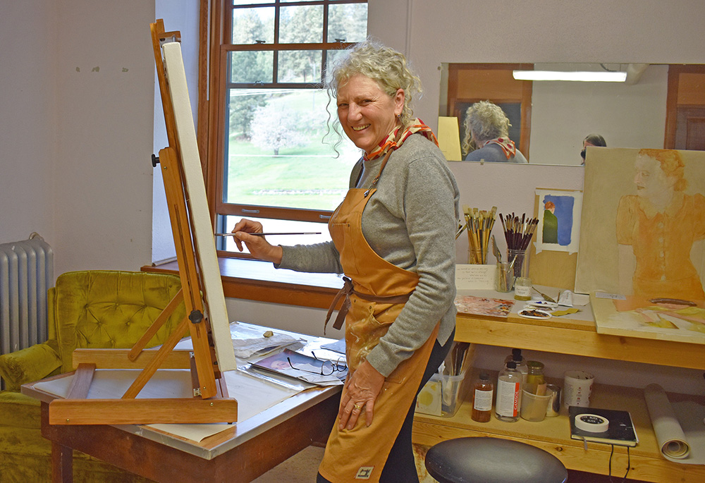 Artist-in-Residence Patricia Altschul, of Sacramento, California, paints in the studio at the Center for Benedictine Life at the Monastery of St. Gertrude, during her stay throughout May. (Julie A. Ferraro)