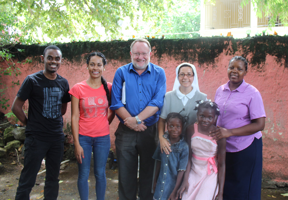 GSR international correspondent Chris Herlinger, seen at center with Haitian and Colombian assignment colleagues, including several sisters, in northeastern Haiti during a 2017 assignment (Courtesy of Chris Herlinger)