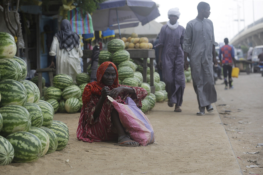 A woman begs on a street in N'Djamena, Chad, on April 26, 2021. (AP/Sunday Alamba)